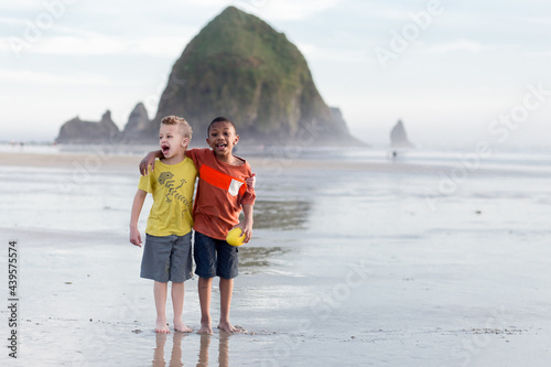 Brothers stand on Cannon Beach
