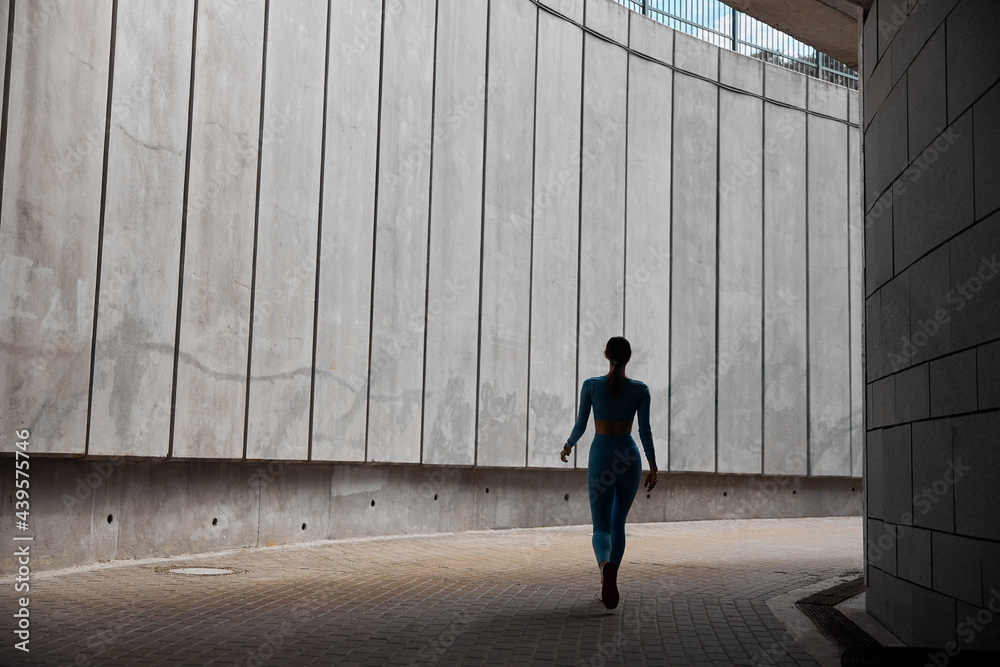 Fototapeta premium Beautiful fit young woman jogger is running outdoors
