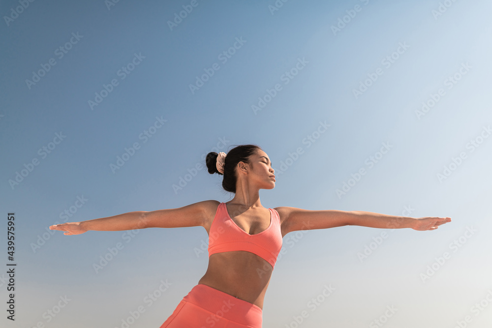 Young Asian woman practicing yoga outdoor. Young Asian woman practicing yoga outdoor.
