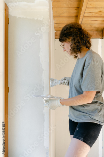 woman plastering her wall  photo