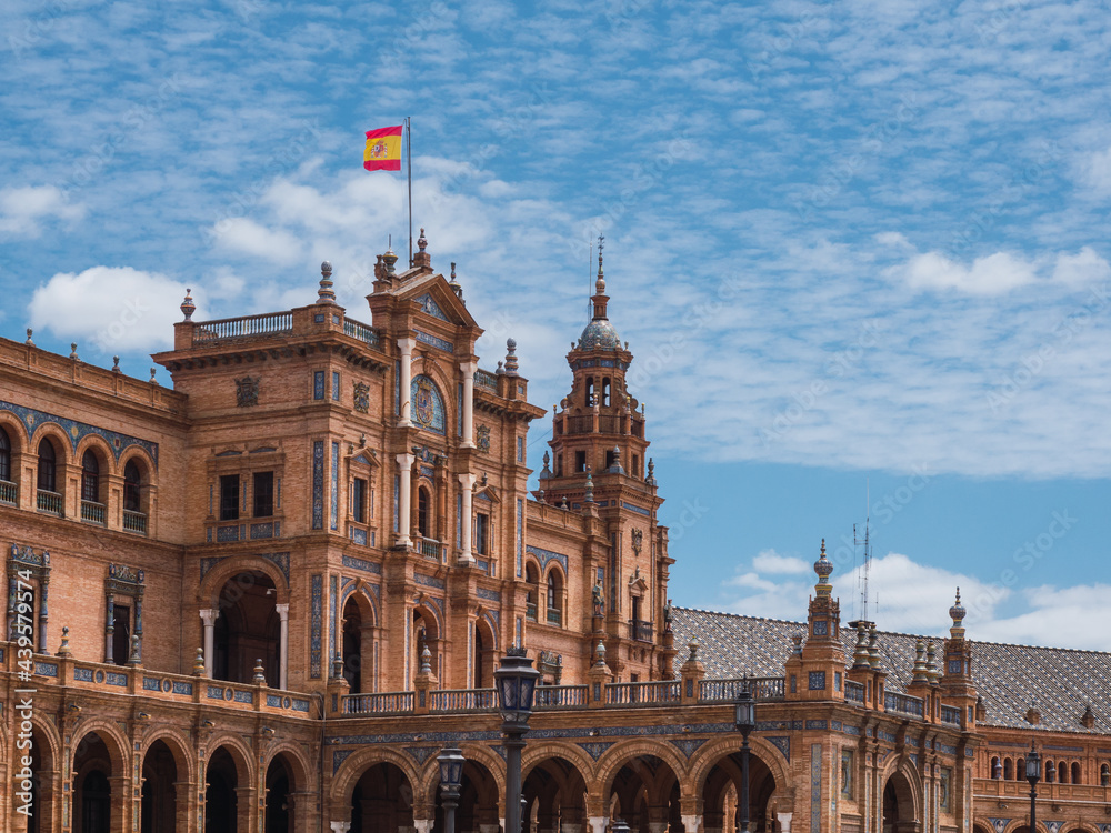 Spanish square (Plaza de Espana) in Maria Luisa park, Seville, Spain, with the Spanish flag on the facade