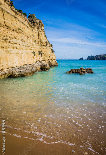 Cliffs of Praia da Dona Ana, sandy beach with clear blue water on a sunny day, no people, Lagos, Algarve, Portugal
