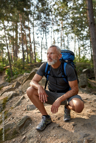 Handsome middle aged caucasian man squatting