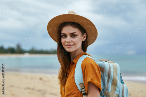 woman tourists in hat with backpack on island landscape © SHOTPRIME STUDIO