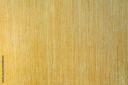 The background image of the wood board has a rough and streaked surface, the wood surface is yellowish-brown.
