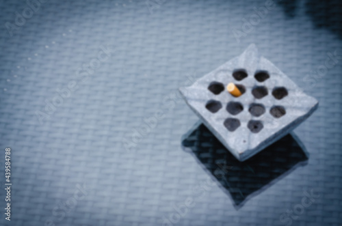 The blurred image of the ashtray was placed on a piece of clear glass.