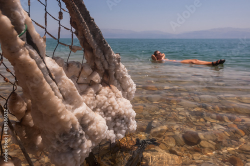Dead Sea salt and a floating person photo