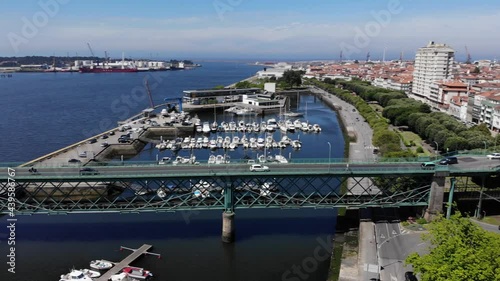 Viana do Castelo, Portugal - June 10, 2021: DRONE AERIAL FOOTAGE - Gustave Eiffel Bridge over the river Lima in Viana do Castelo. Aerial panoramic cityscape view of Viana and the Marina.