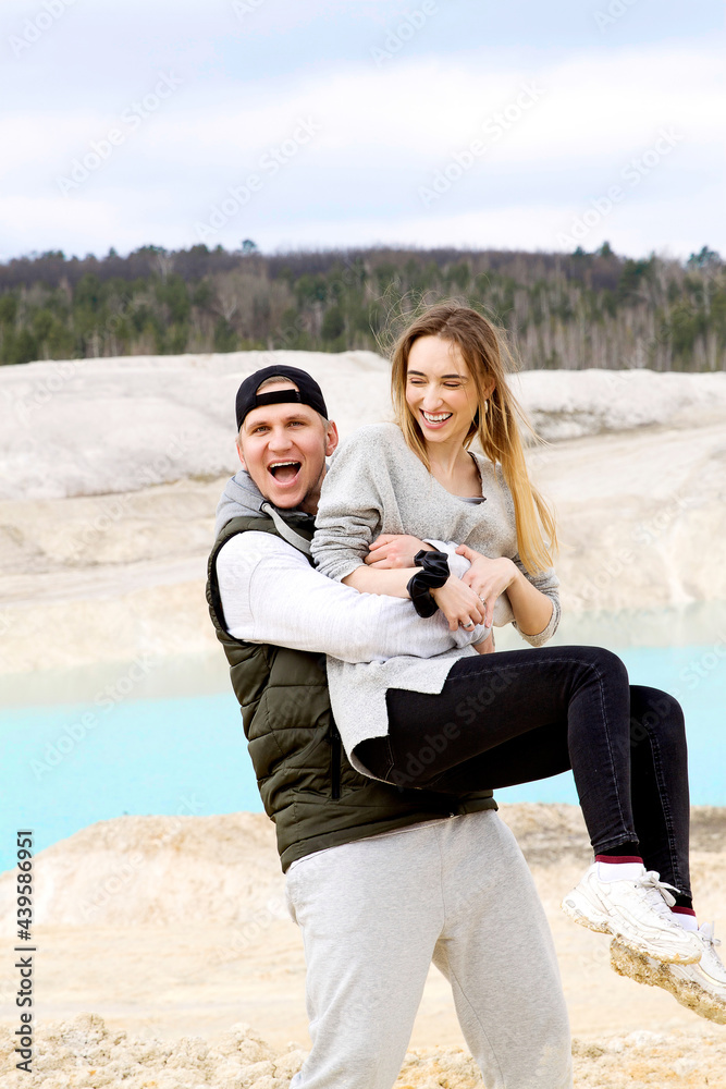 Emotional happy couple close up on the background of a blue lake outside the city