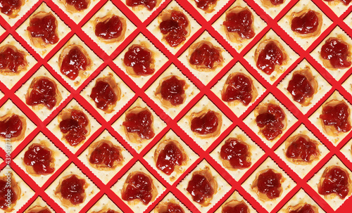 Diagonal View of Soda Crackers with Peanut Butter and Jam 