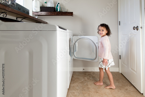 Girl holds dryer door open