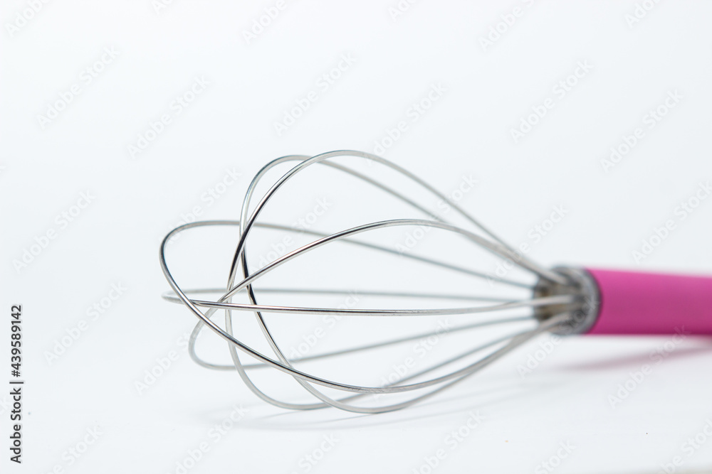 Steel whisk on a white background. Kitchen tool. Whipping tool Steel whisk on a white background. Kitchen tool. Whipping tool
