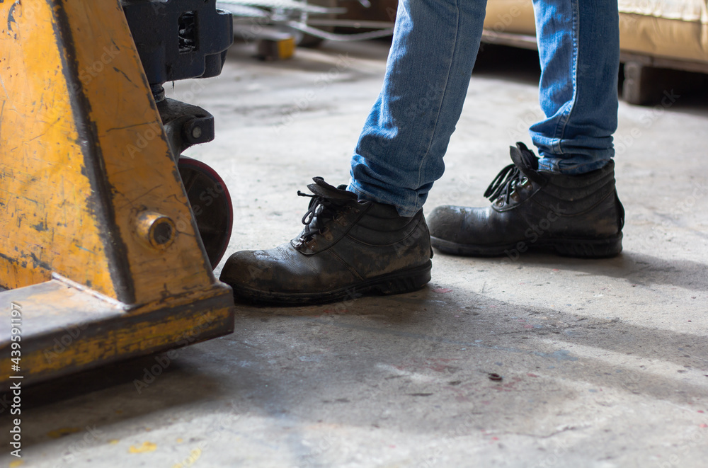 Wear safety shoes to ensure safety at work. construction workers wear