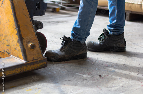 Wear safety shoes to ensure safety at work. construction workers wear safety shoes. People with factory safety concept