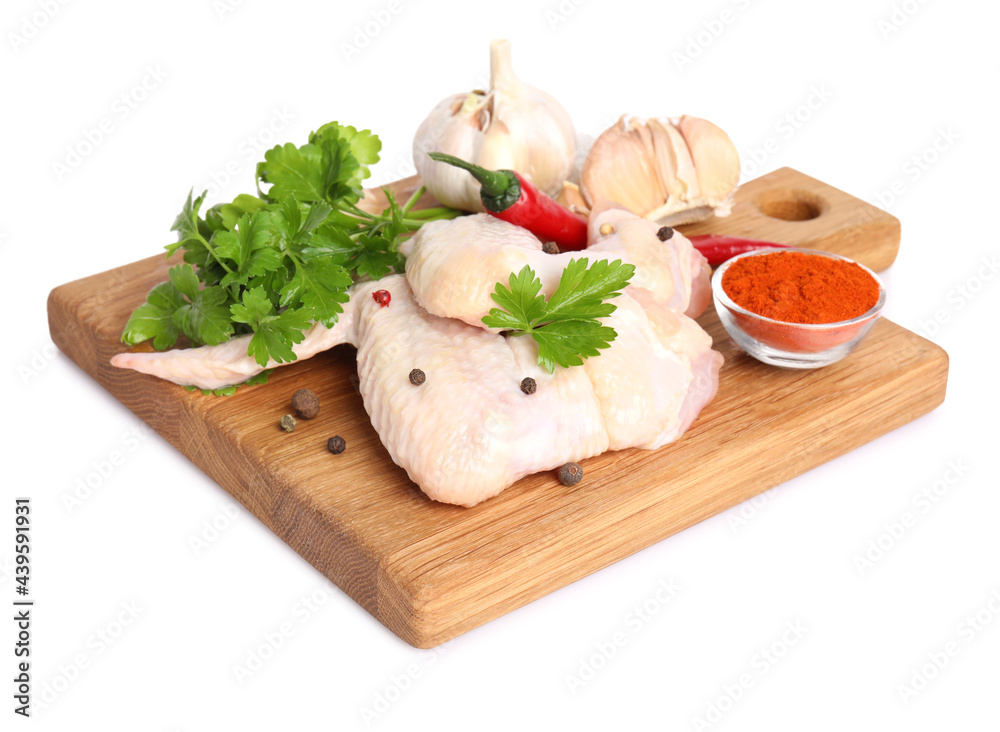 Raw chicken wings with spices and parsley on white background Raw chicken wings with spices and parsley on white background