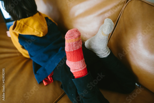 Childs feet with mismatched socks photo