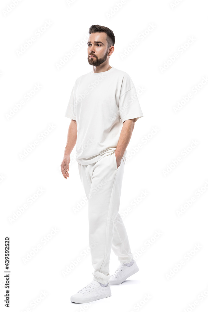 Fototapeta premium Handsome man wearing white clothes with a blank space for design on white background