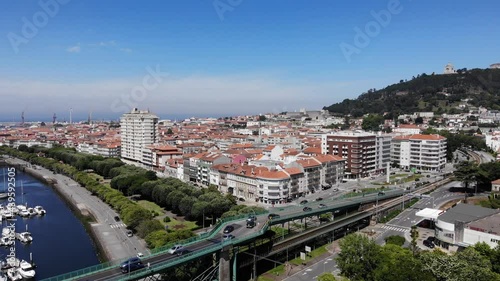 Viana do Castelo, Portugal - June 10, 2021: DRONE AERIAL FOOTAGE - Gustave Eiffel Bridge over the river Lima in Viana do Castelo. Aerial panoramic cityscape view of Viana and the Marina.