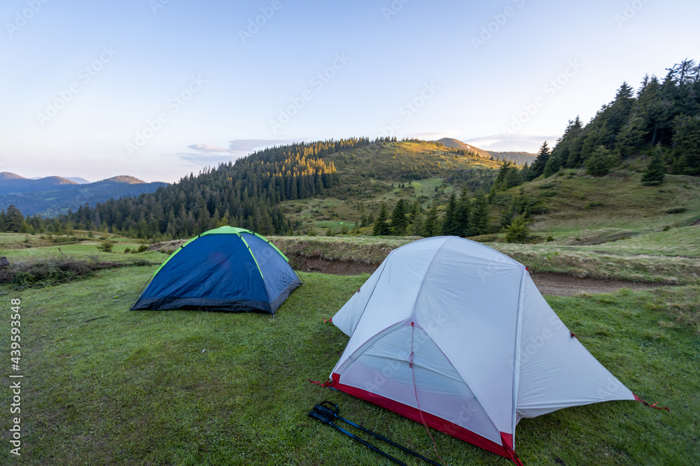 Hiking tents in the mountains set outdoor. Colorful trekking tents outsige