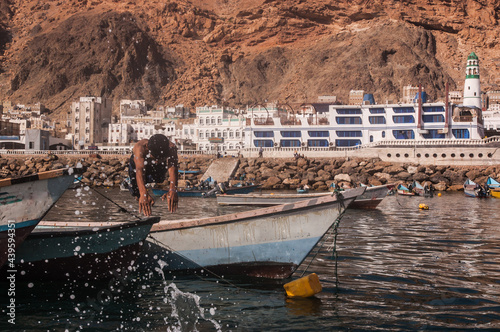 man dives from small boat in yemen photo