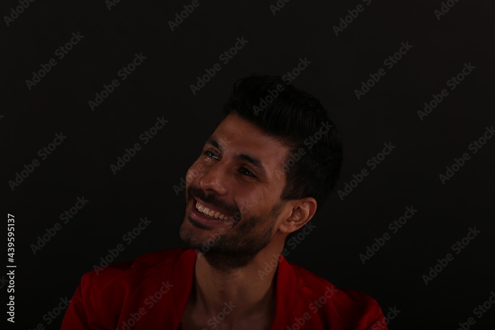 Portrait of a smiling man on black background