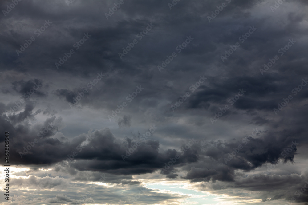 Dark clouds before a thunderstorm . Hurricane heaven . Black sky before storm 