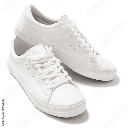 Pair of white leather trainers on white background