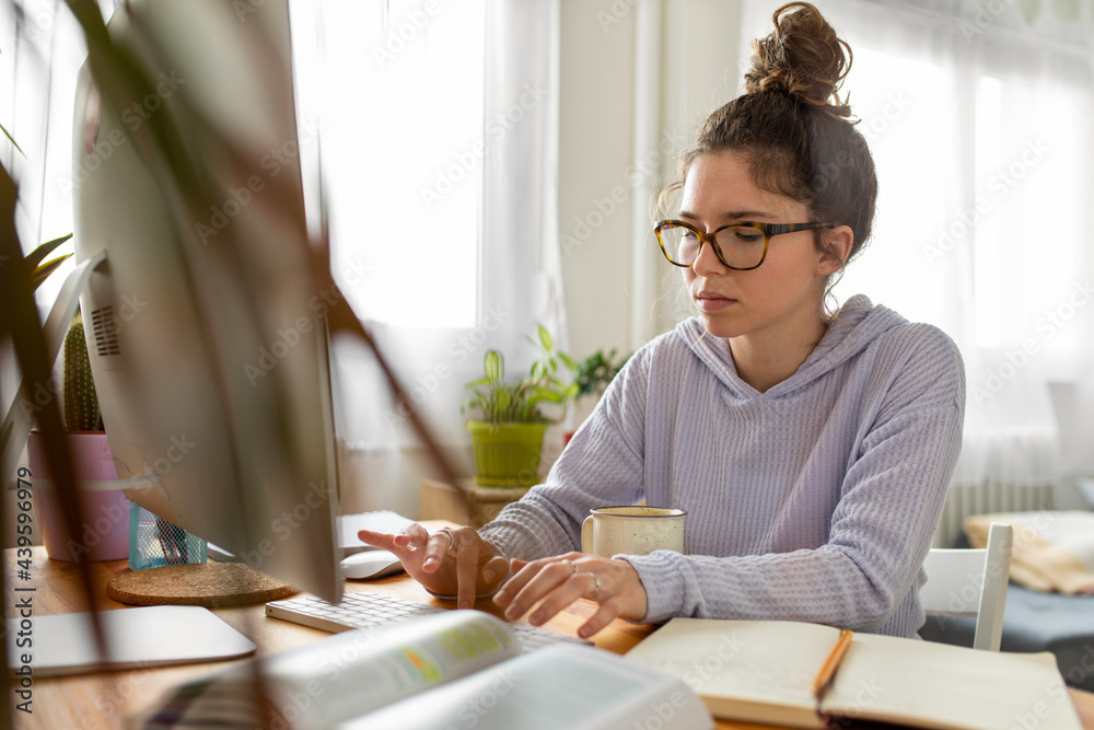 Young woman studying at home Young woman studying at home