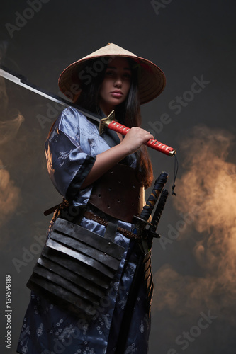 Japanese woman assassin with bamboo hat and katana