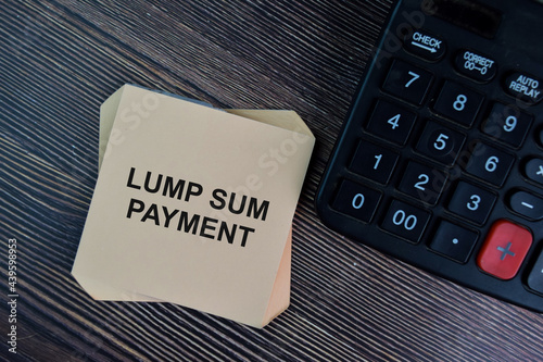 Lump Sum Payment write on sticky notes isolated on Wooden Table. photo