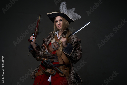 Female model dressed in corsair clothing with gun