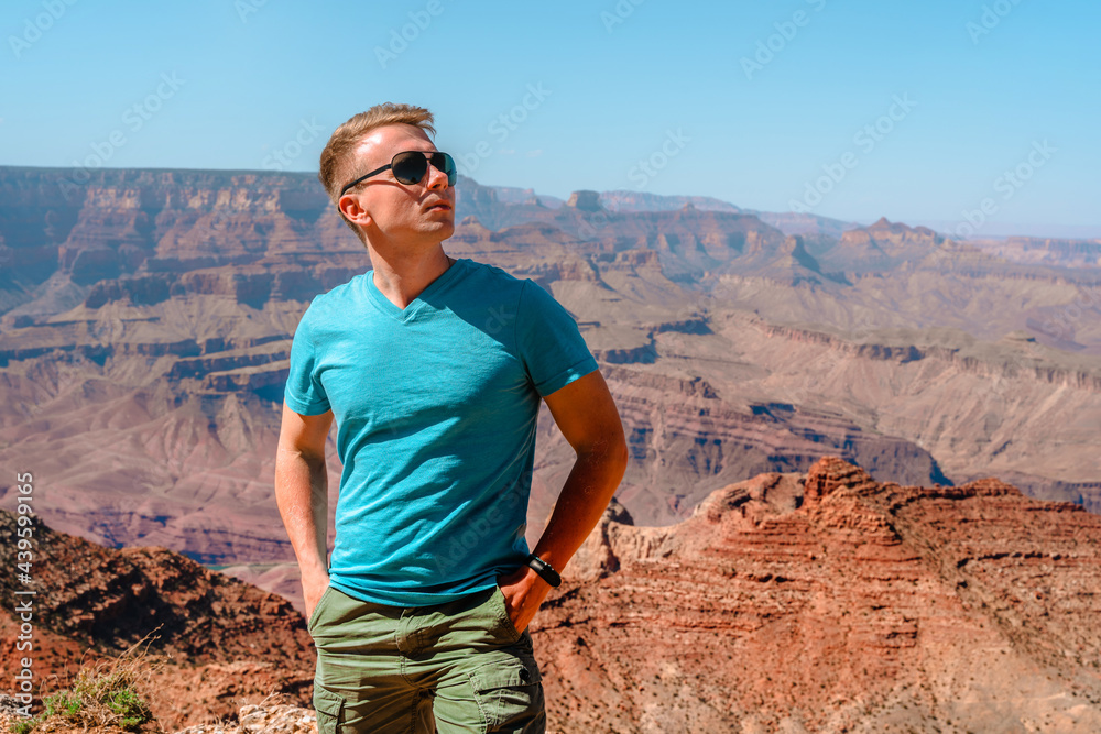 Young man blonde tourist walks in Grand Canyon National Park, Arizona Young man blonde tourist walks in Grand Canyon National Park, Arizona