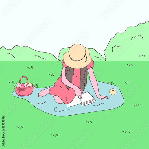 picnic basket on a blanket over green grass in the park