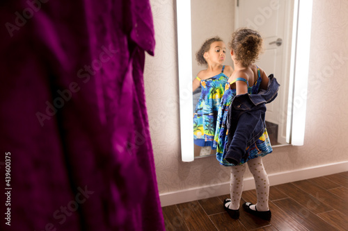 Girl struts for dressing room mirror
