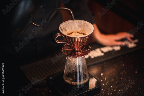Cafe staff pour hot water into coffee beans to drip coffee for good smell and good quality serve customers ,who order to taste.