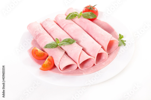 sliced ham and basil on plate