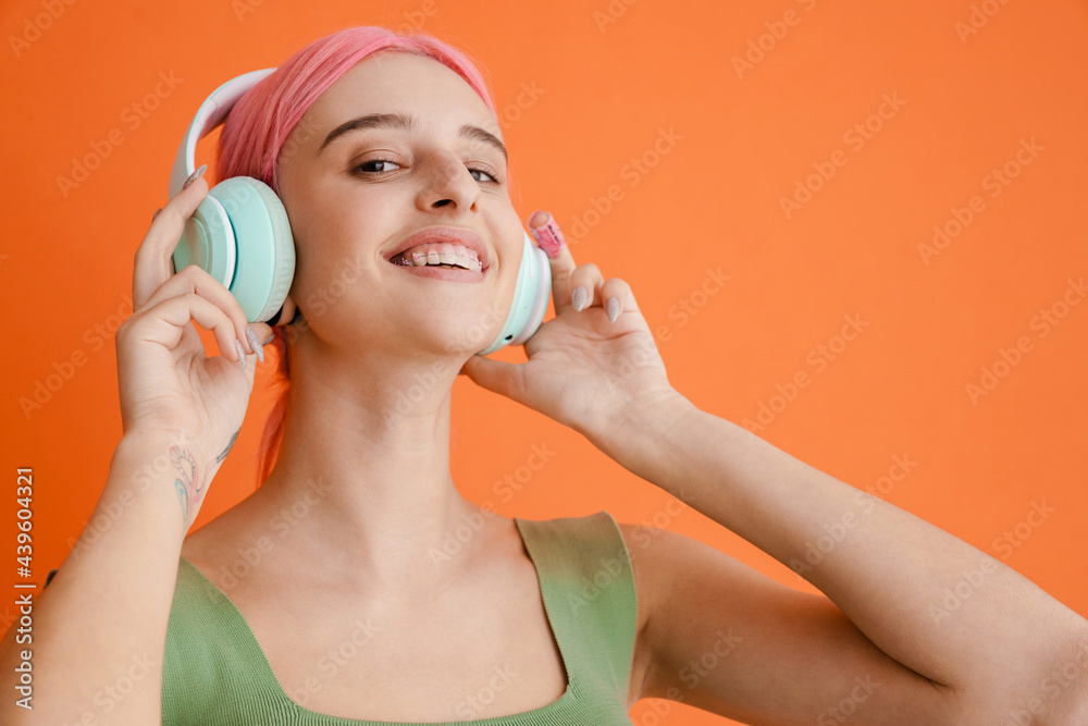 Young white woman with pink hair posing and looking at camera Young white woman with pink hair posing and looking at camera