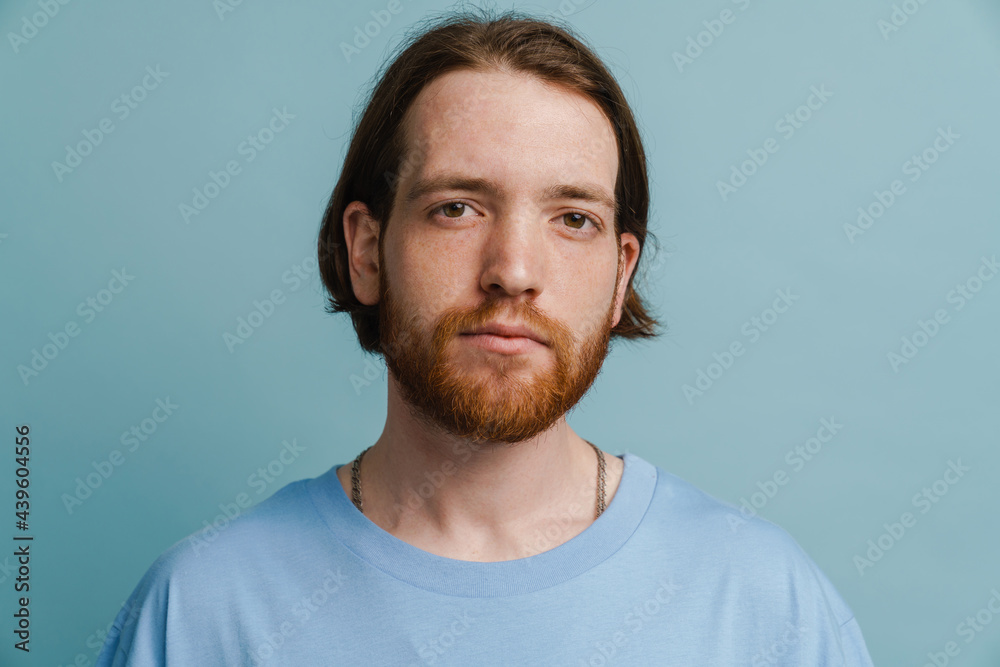 Young ginger man with beard posing and looking at camera Young ginger man with beard posing and looking at camera
