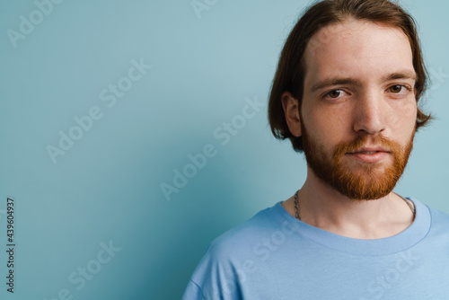 Young ginger man with beard posing and looking at camera