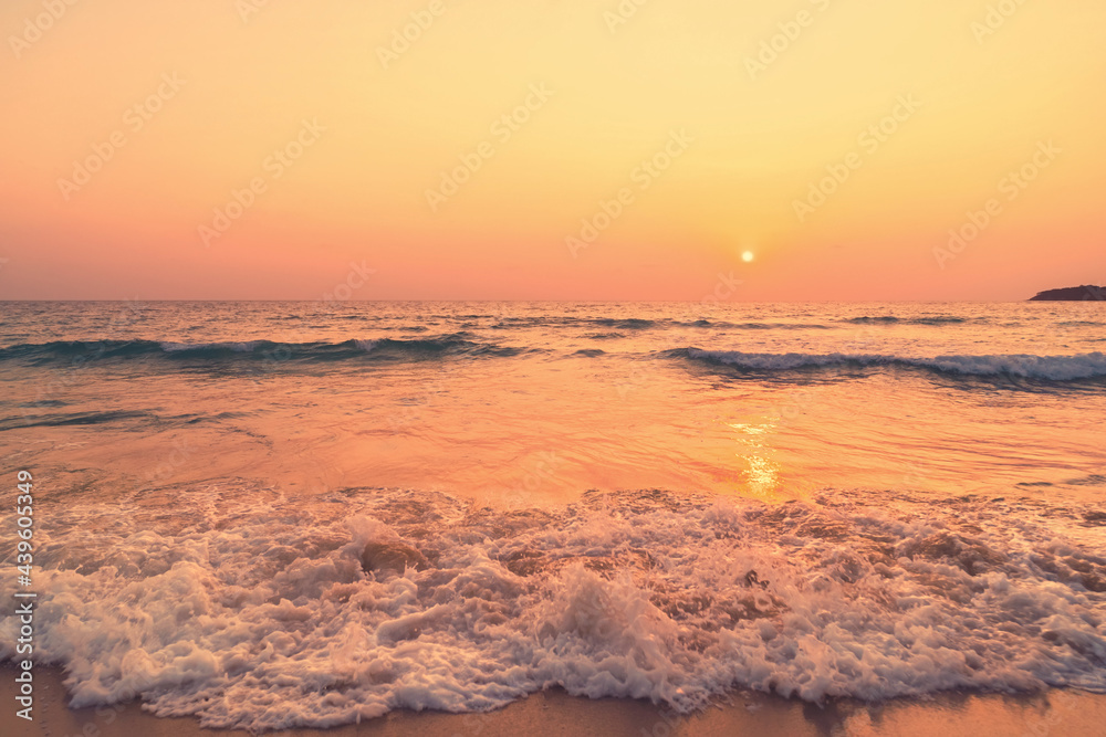 Fototapeta premium Tropical beach with smooth wave and sunset sky abstract background.