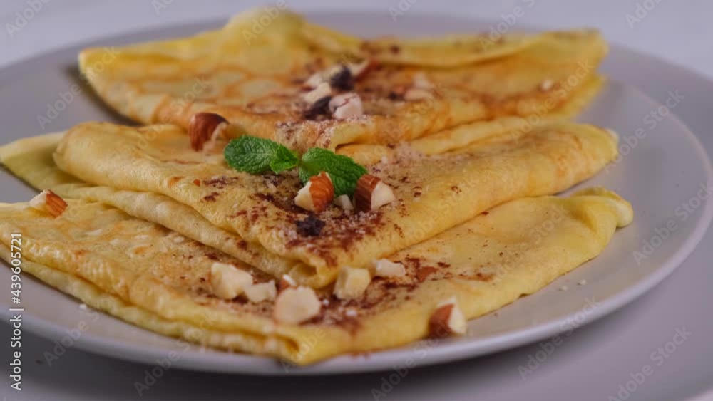 Rotation pancakes with chocolate spread and nuts, delicious breakfast Rotation pancakes with chocolate spread and nuts, delicious breakfast