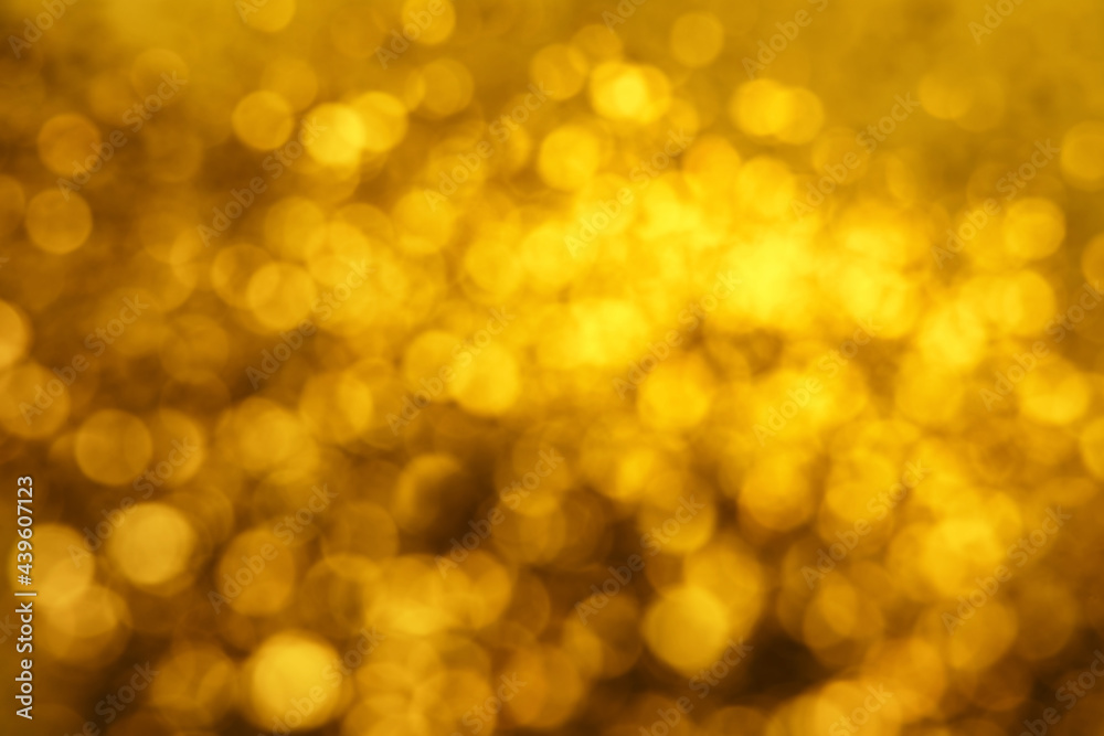 Blurred view of golden lights as background. Bokeh effect