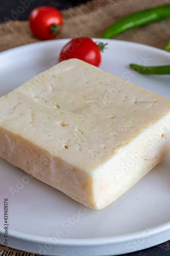 Soft feta cheese on dark background
