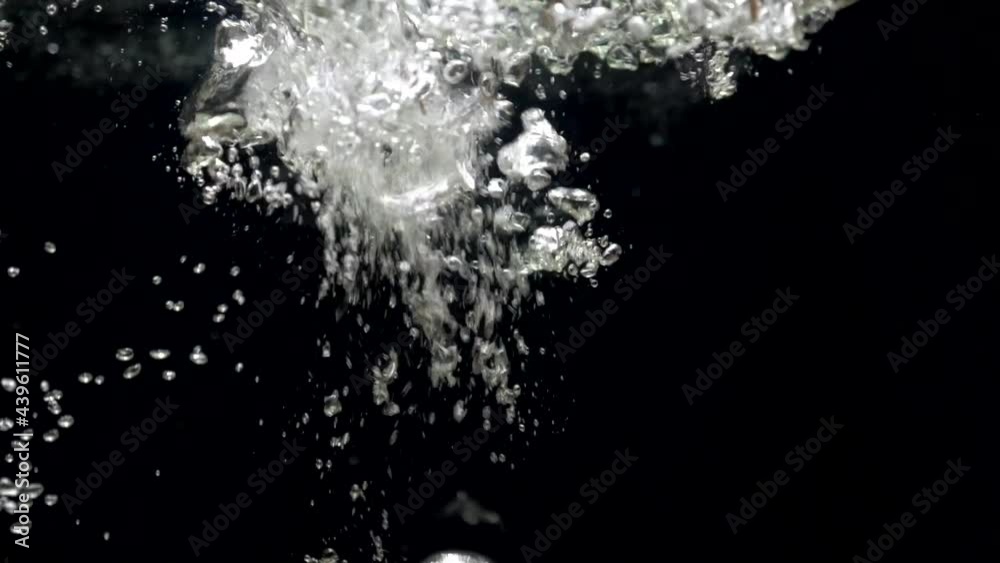 Slow motion close up air bubbles in water rising up to the surface on isolated black background. Slowmotion air bubbles floating under transparent water bubbles in aquarium Slow motion close up air bubbles in water rising up to the surface on isolated black background. Slowmotion air bubbles floating under transparent water bubbles in aquarium