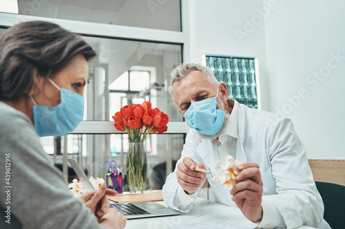 Doctor conducting a female patient initial consultation photo