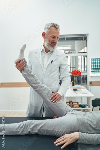 Vertebrologist performing a straight leg raise test
