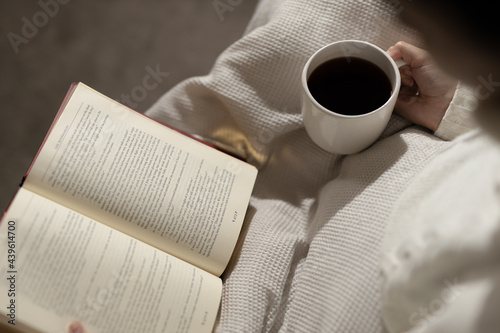 girl reading book and drinking coffee