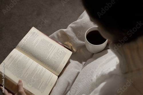girl reading book and drinking coffee