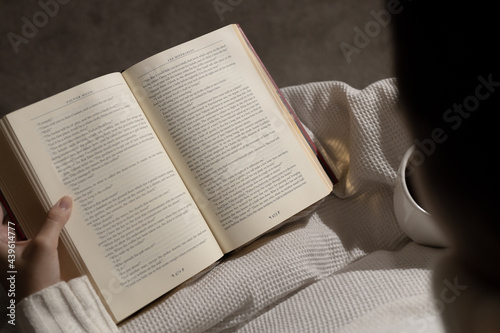 girl reading book and drinking coffee