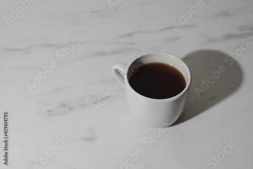 Hot cup of coffee on desk 